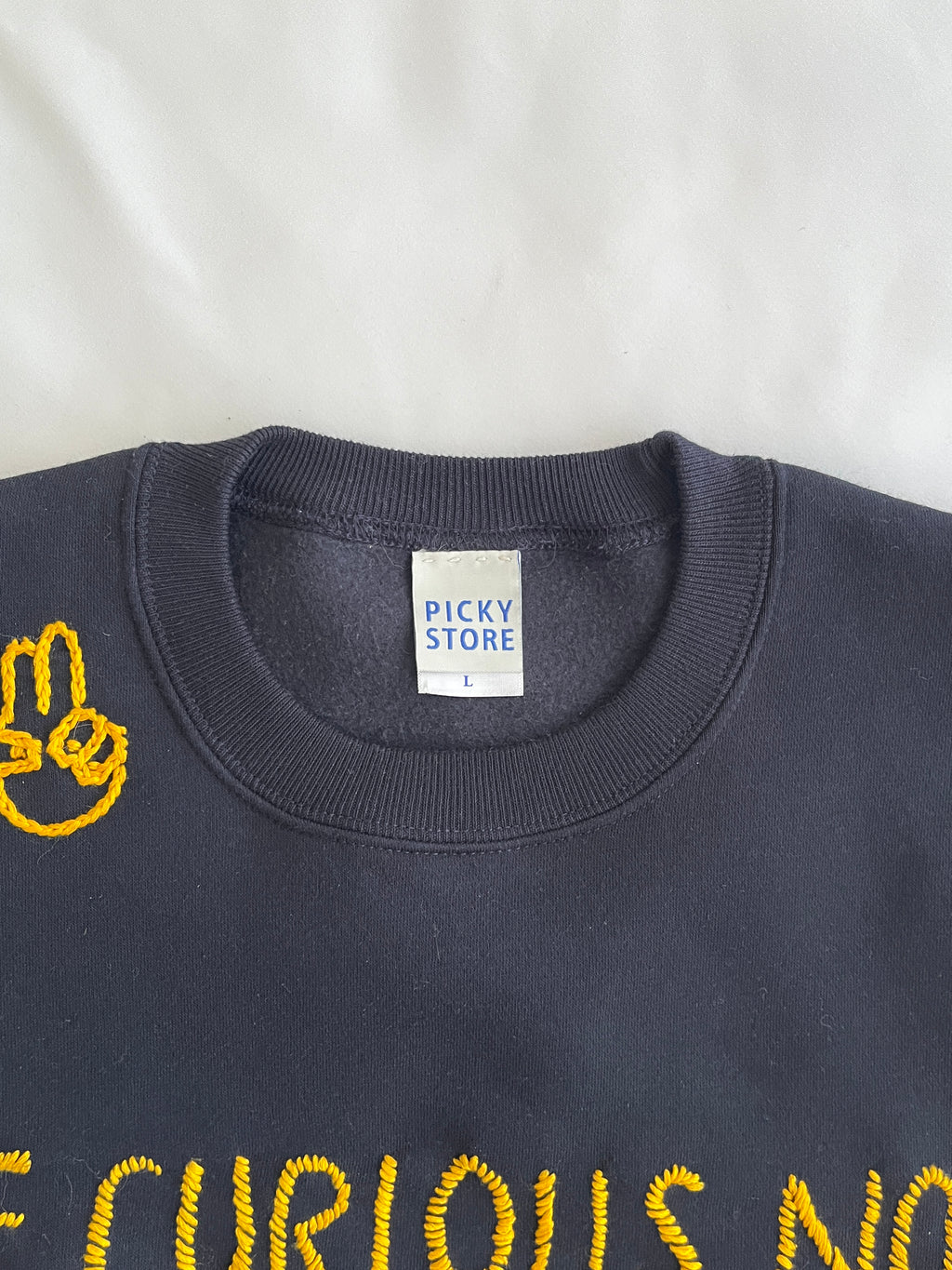 スウェット　"BE CURIOUS" embroidery
